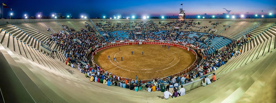 people gathered at the event inside bull riding stadium, bull ring