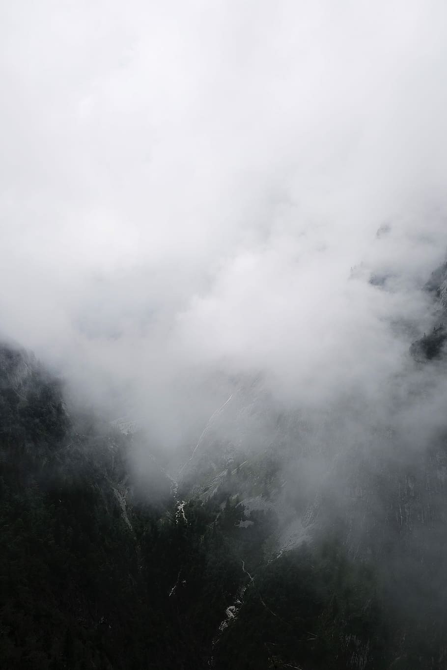 mountains and smoke during daytime, white smoke, drone view, aerial