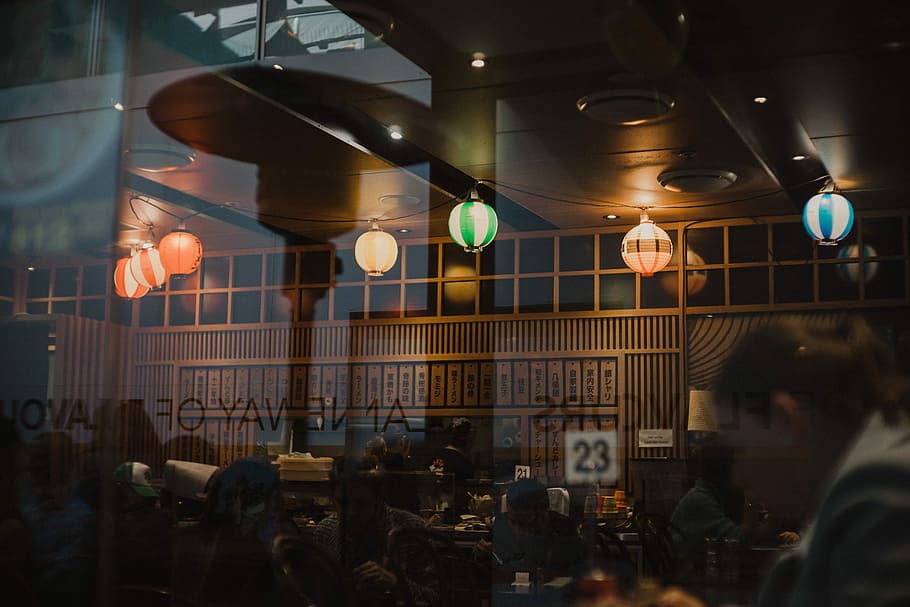 patio heater reflecting on glass window, people inside food stall HD wallpaper