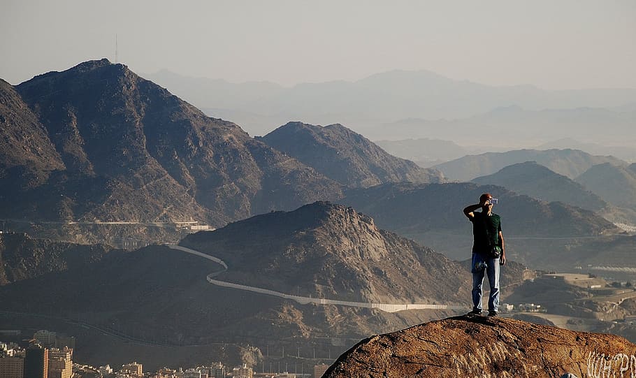 man standing on cliff near city during daytime, Mountains, Distant View HD wallpaper
