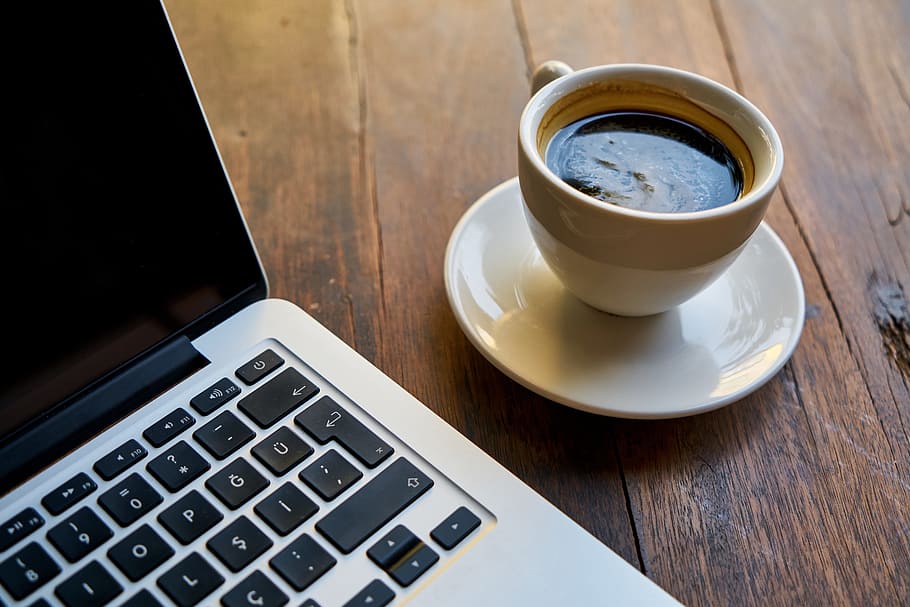 brown ceramic teacup on saucer beside MacBook Pro, coffee, computer HD wallpaper