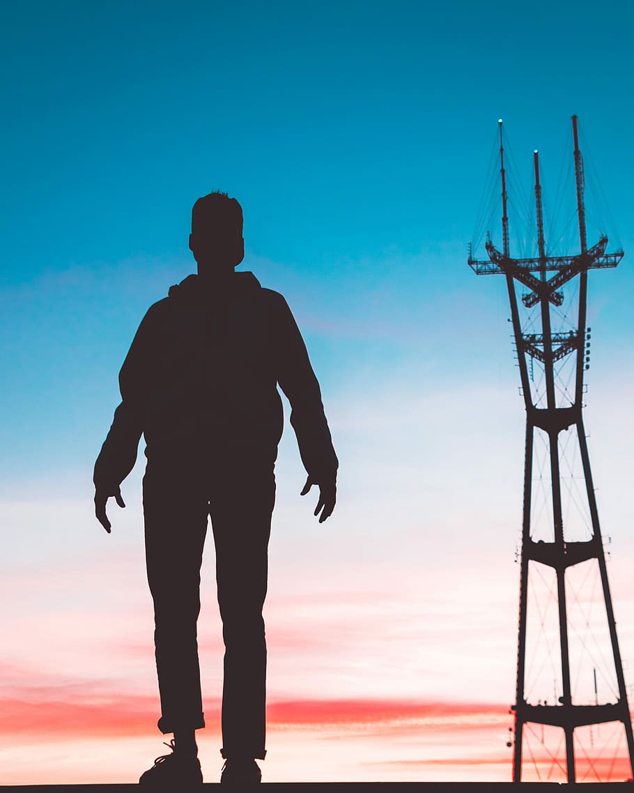 silhouette photography of man standing in front of transmission tower, person standing near industrial plant shadow photography during sunset, HD wallpaper