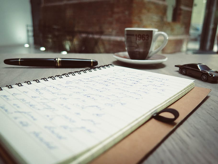 black pen near white spiral book on black wooden desk, notebook HD wallpaper