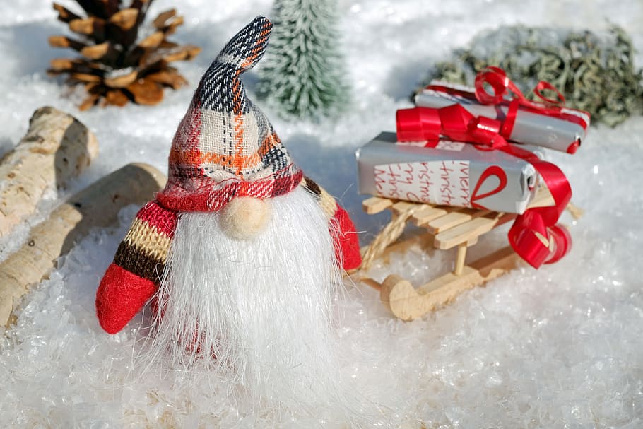 gnome standing on snow miniature figure, santa claus, christmas motif