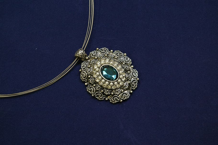 oval green gemstone encrusted gold-colored pendant necklace, jewellery