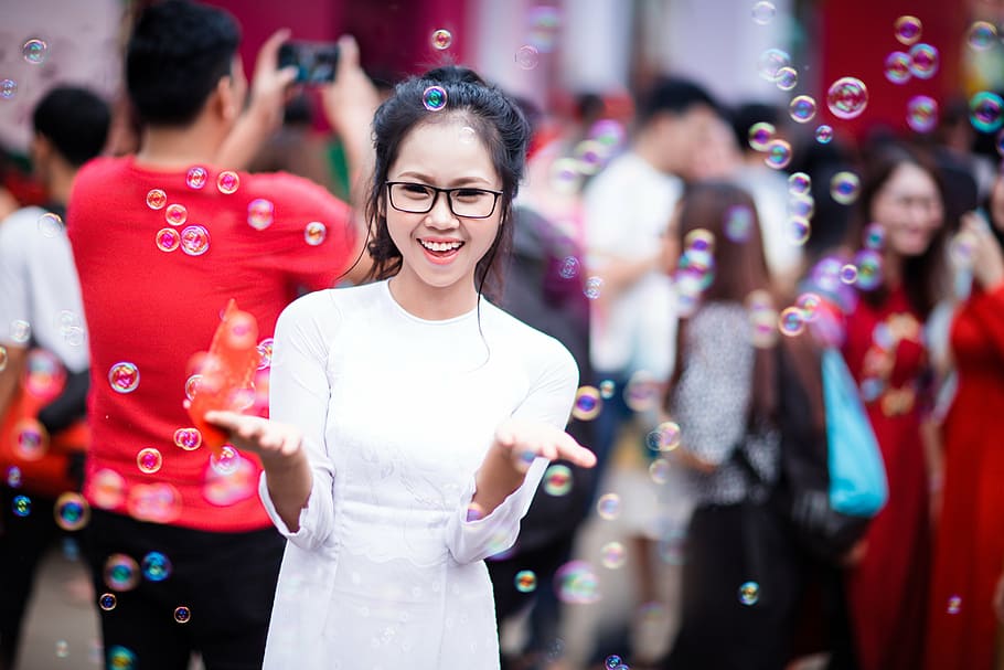 selective focus photo of woman surrounded with bubbles located in the crowd during daytime, HD wallpaper