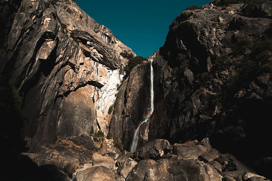 landscape photography of waterfalls, low angle photography of mountain under blue sky HD wallpaper