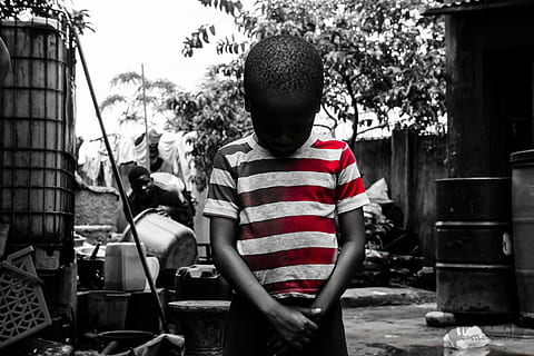 selective color photography of boy wearing stripe shirt looking down HD wallpaper
