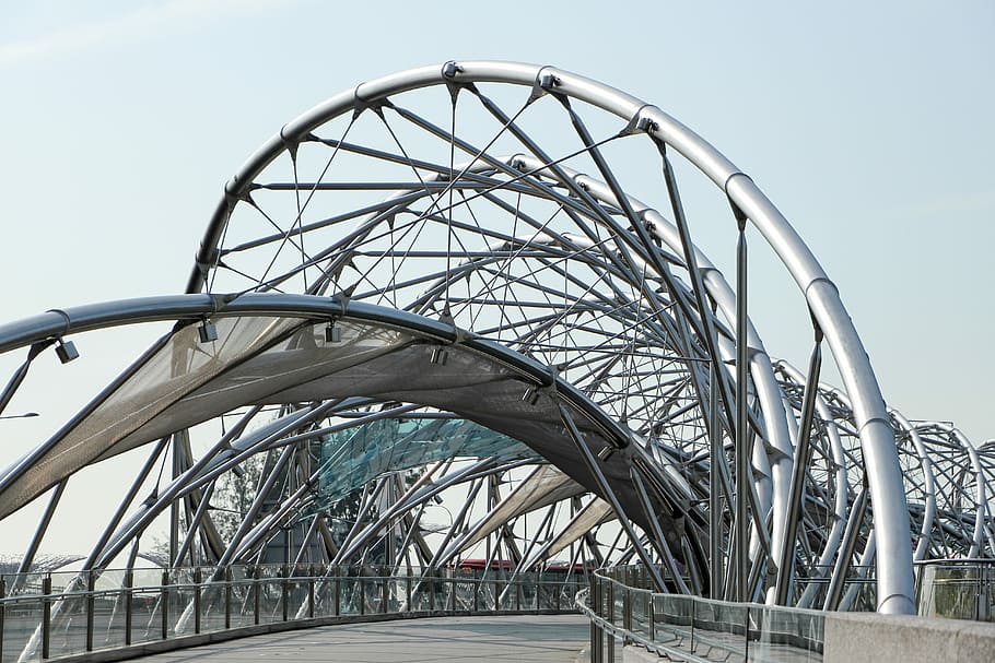low angle photography of pathway under gray metal spiral frame, pathway between gray metal frame HD wallpaper