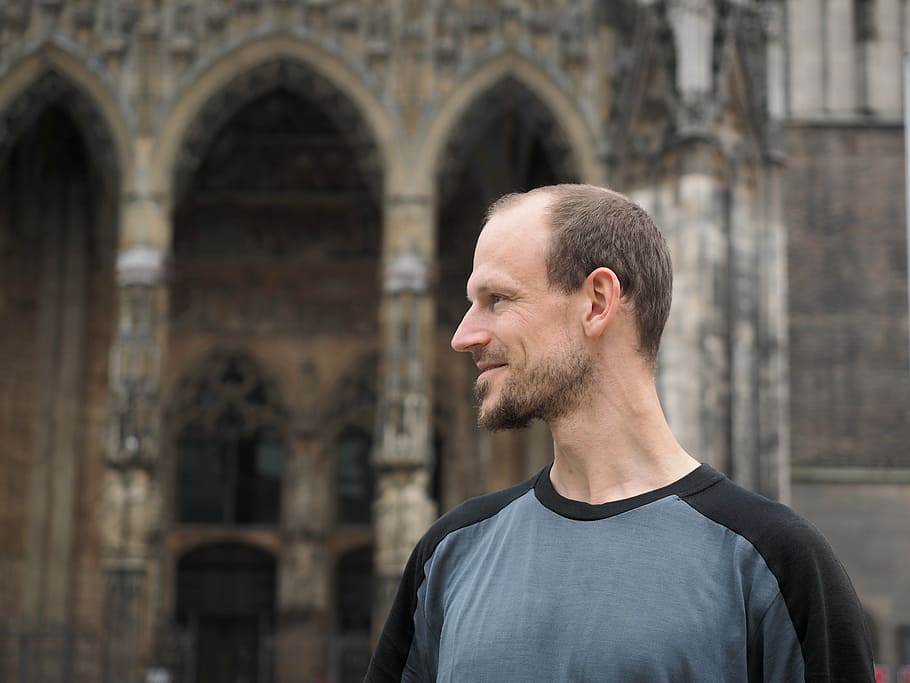 man standing beside cathedral, profile, face, person, human HD wallpaper