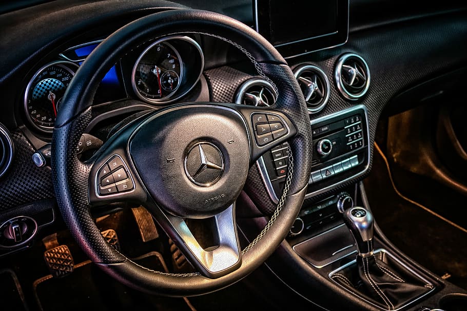 closeup photo of black Mercedes-Benz steering wheel airbag, cockpit