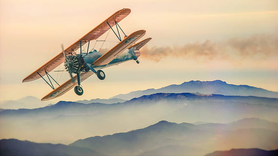 illustration of brown and blue biplane flying over mountain HD wallpaper