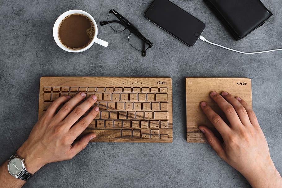 Young man typing on the wooden keyboard, workspace, workplace, HD wallpaper