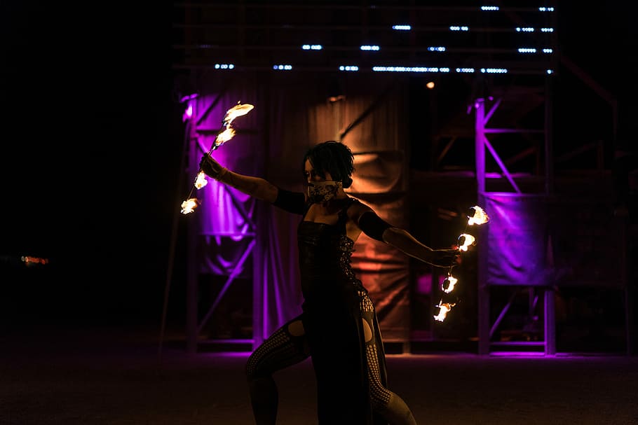 woman holding fire dancing rod while dancing on stage, woman fire dancing HD wallpaper