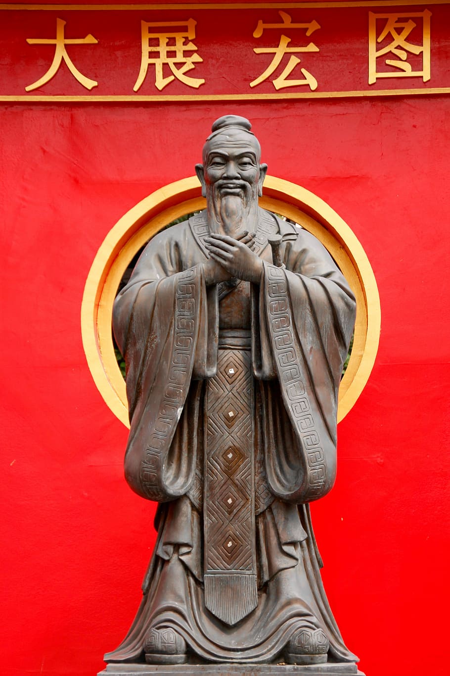 brown concrete human statue near red textile, Confucius, China