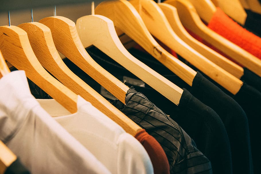 clothes hanged on brown wooden hanger, selective focus photography of assorted-color shirts and clothes hanger, HD wallpaper
