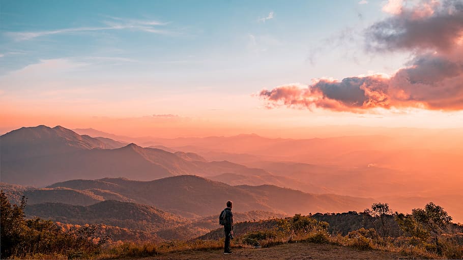 man standing on hill digital wallpaper, person standing near mountain HD wallpaper