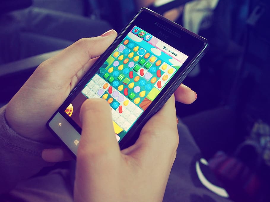 person holding Windows phone, candy crush, device, electronics