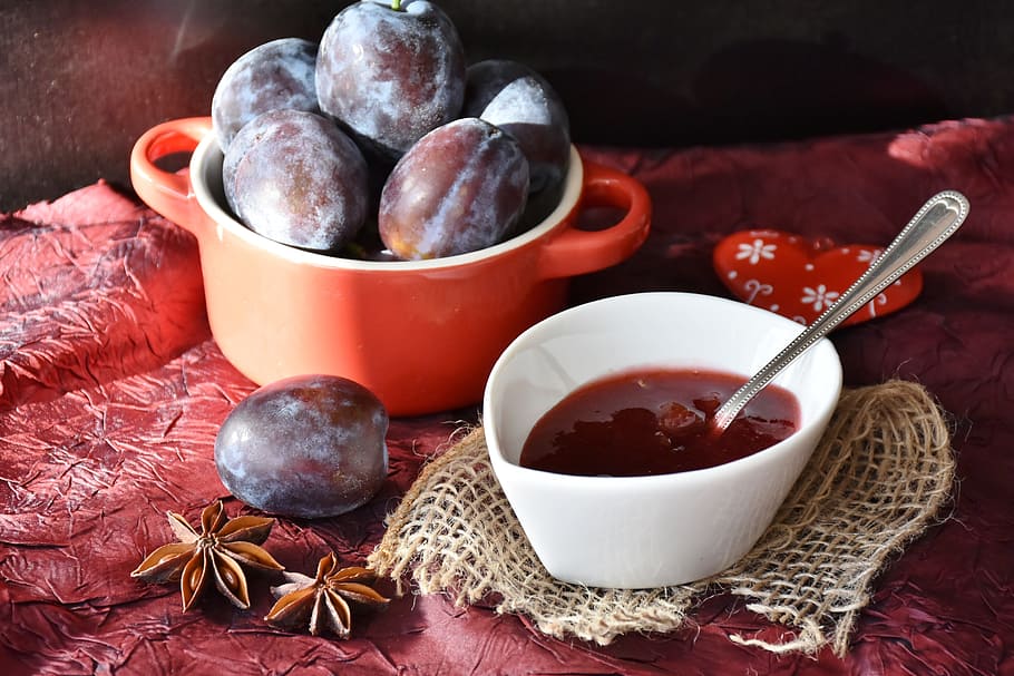 food photography of white ceramic bowl with red liquid, plums HD wallpaper