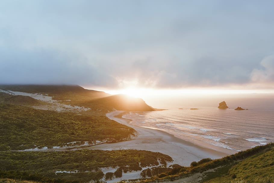landscape photo of mountain and ocean, mountain beside shoreline HD wallpaper