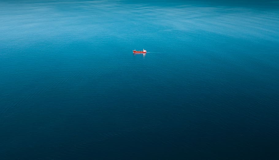 red ship sailing on body of water alone, red boat sailing on body of water HD wallpaper