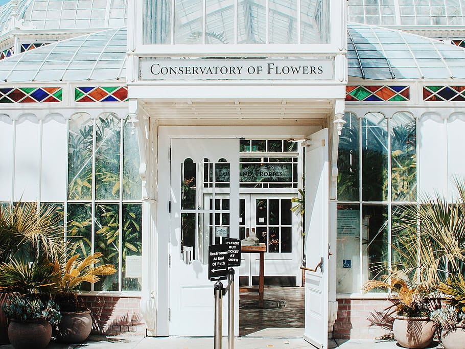 white Conservatory of Flowers building, open door of Conservatory of Flowers entrance