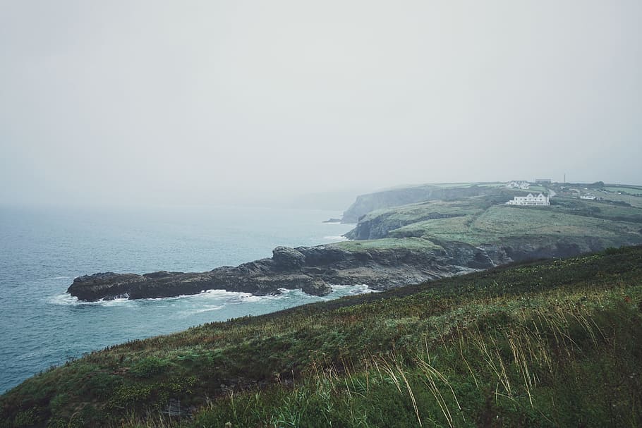 aerial photography of mountain near body of water, landscape, photo, mountain, sea, nature, coastline HD wallpaper
