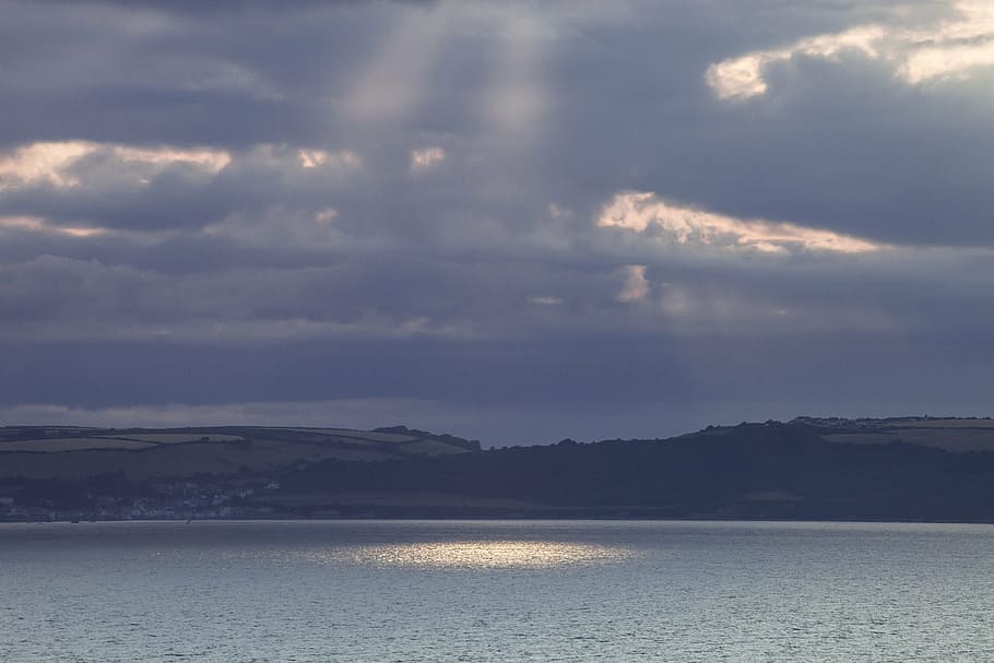 landscape, sea, sunbeam, clouds, lighting, dramatic, hill, forest HD wallpaper