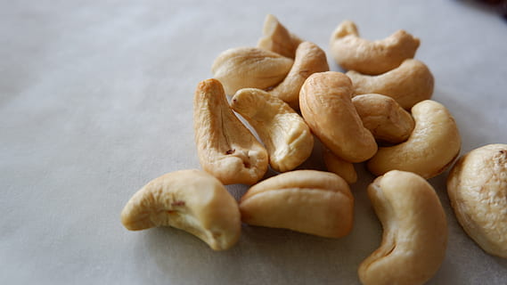 cashew nuts on white surface, sweets, food, food and drink HD wallpaper