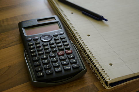 black graphing calculator beside spiral note book, notepad HD wallpaper