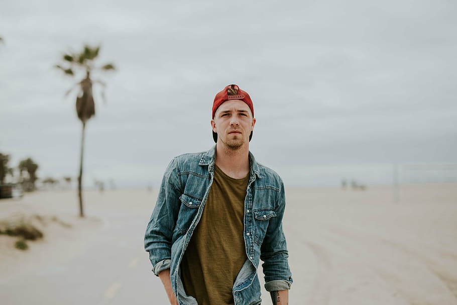 man wearing denim jacket and red cap walking along road, people HD wallpaper