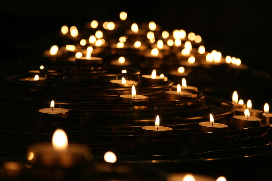 low-angle photo of lightened candles, lighted tealight candles
