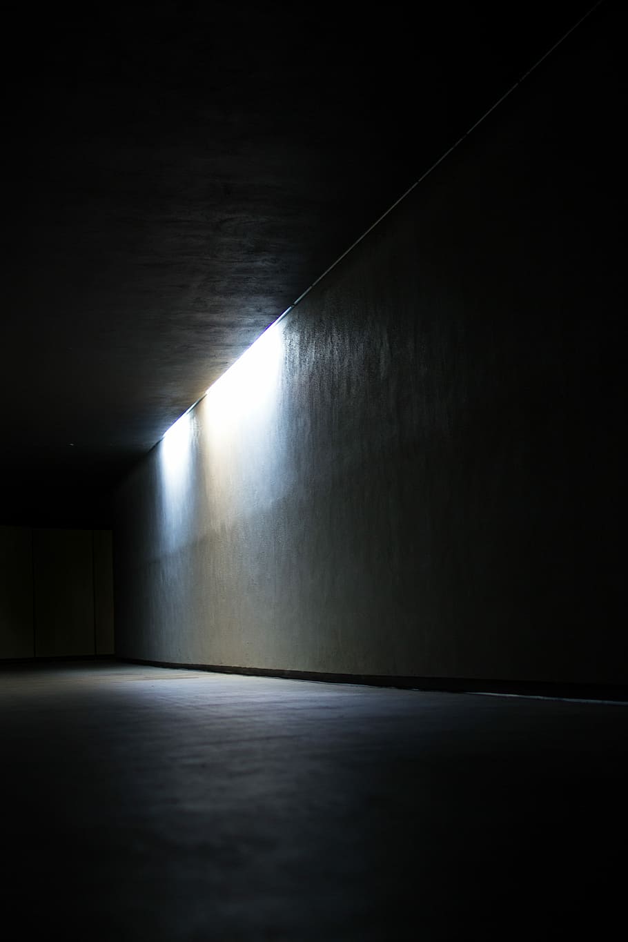 dim lighted room, white concrete wall, tunnel, shadow, perspective