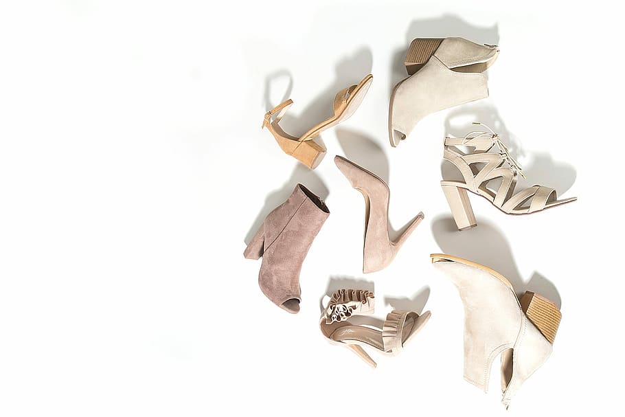 women's seven assorted-color footwear on surface, several unpaired gray and brown shoes and sandals with white background HD wallpaper