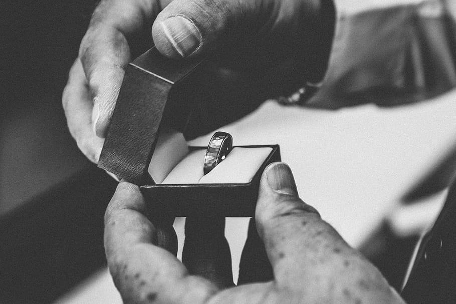 grayscale photography of person holding silver-colored ring in opened box, grayscale photo of person opening ring box HD wallpaper
