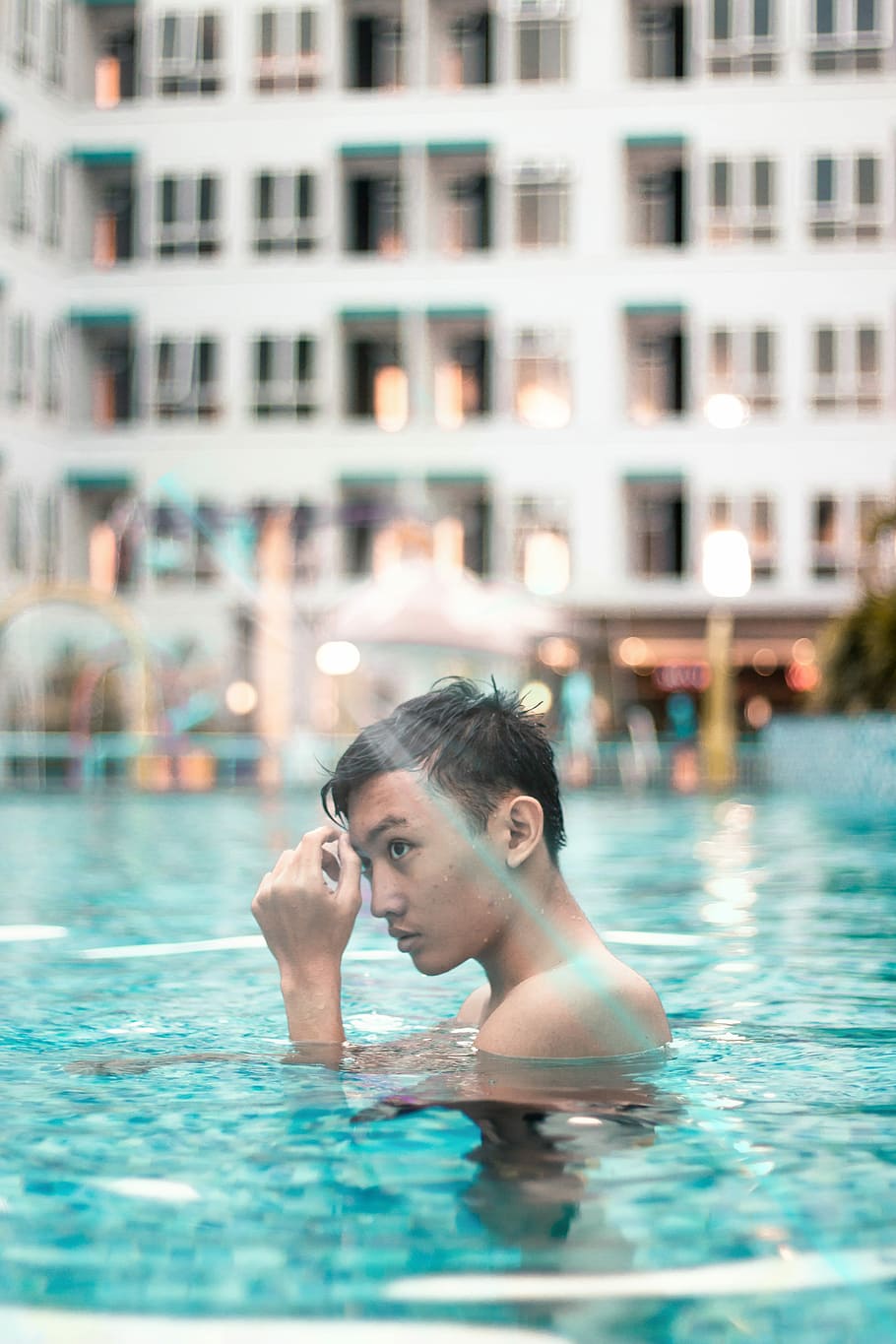 close-up photo of man bathing on swimming pool, man on the swimming pool