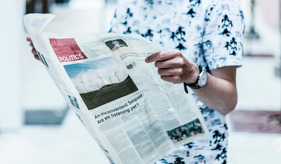 selective focus photography of person holding newspaper, man holding newspaper HD wallpaper