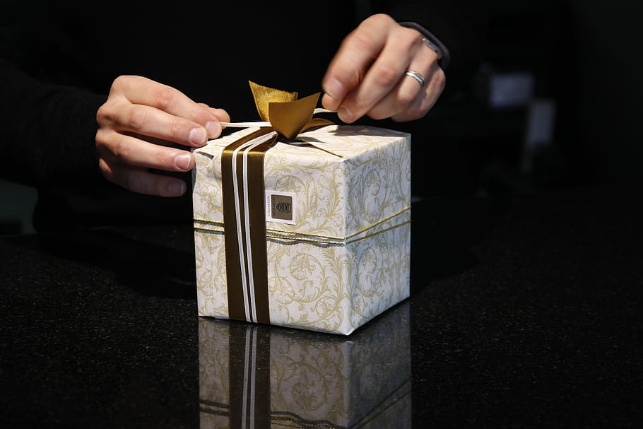 white and gray gift box on person's hand, packaging, loop, christmas HD wallpaper