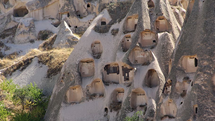 houses on cliff during daytime, cappadocia, kapadokya, uchisar