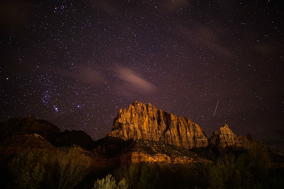 brown rocky mountain near body of water at night, brown mountain at nighttime HD wallpaper