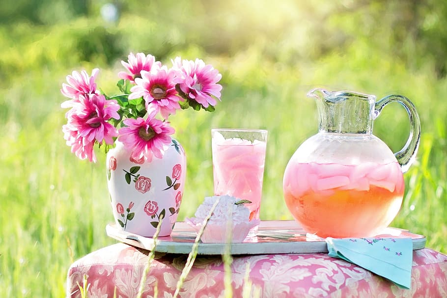 clear glass of pitcher with juice near glass full of juice and pink flowers in vase on table, HD wallpaper