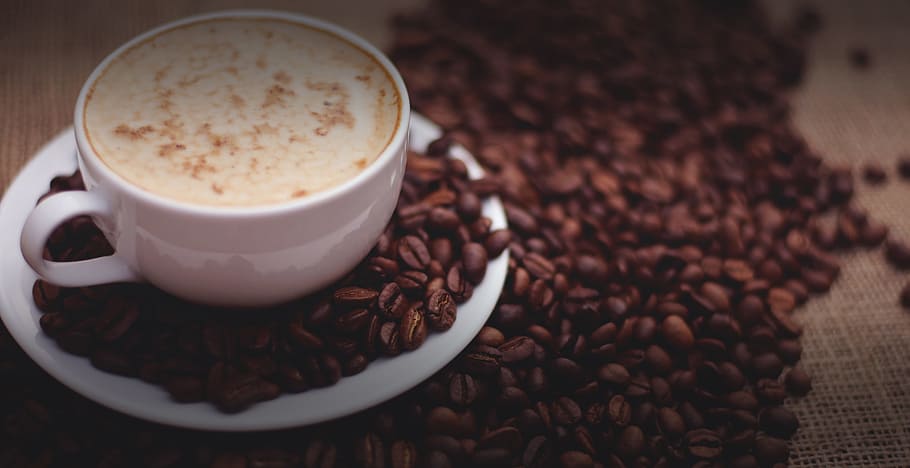 filled white cup on top of white saucer surrounded by coffee beans, ceramic mug on saucer filled with coffee near coffee beans HD wallpaper