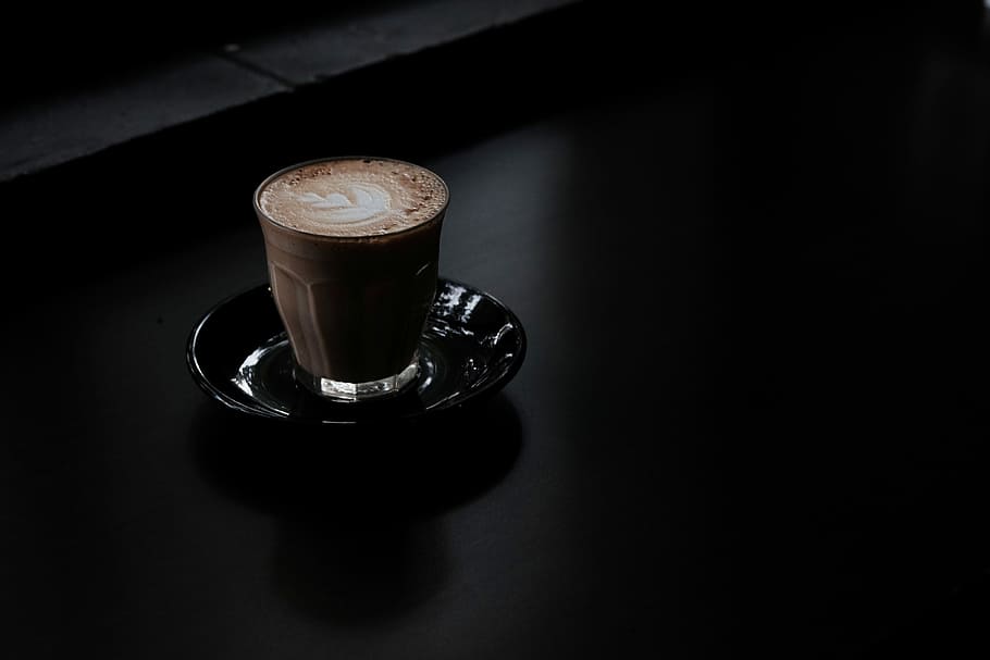 clear glass mug with coffee, cappuccino on saucer, hot chocolate
