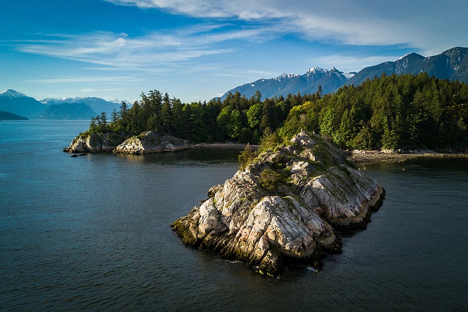 New Perspectives, landscape photo of rock isle near tree-covered land aerial photo HD wallpaper