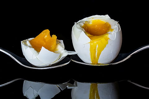 two poultry eggs on spoon, bisected egg, boiled egg, yolk, egg yolk HD wallpaper