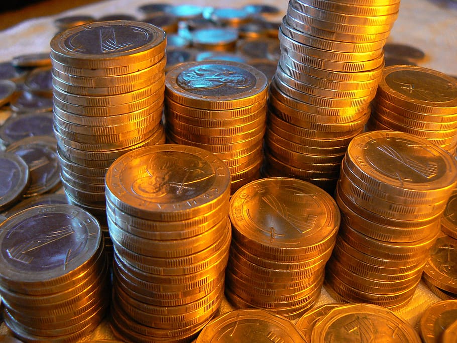 close-up photo of pile of round gold-colored coins, money, finance