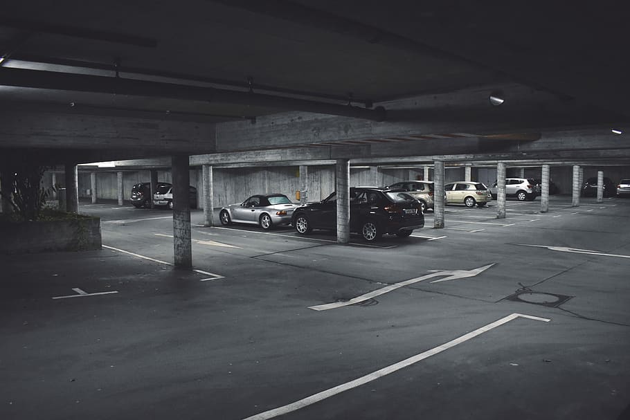 cars parked on parking area, grayscale photography of parked cars