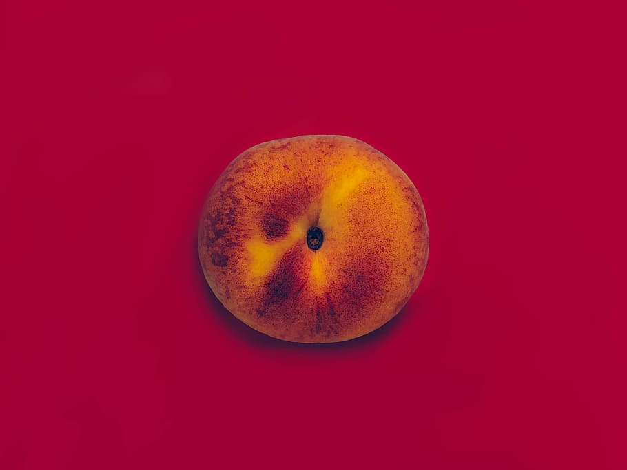 round apple fruit candle, orange eye decor, red background, topdown HD wallpaper