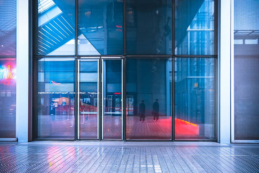reflection of two men walking on glass building wall, glass panel door HD wallpaper