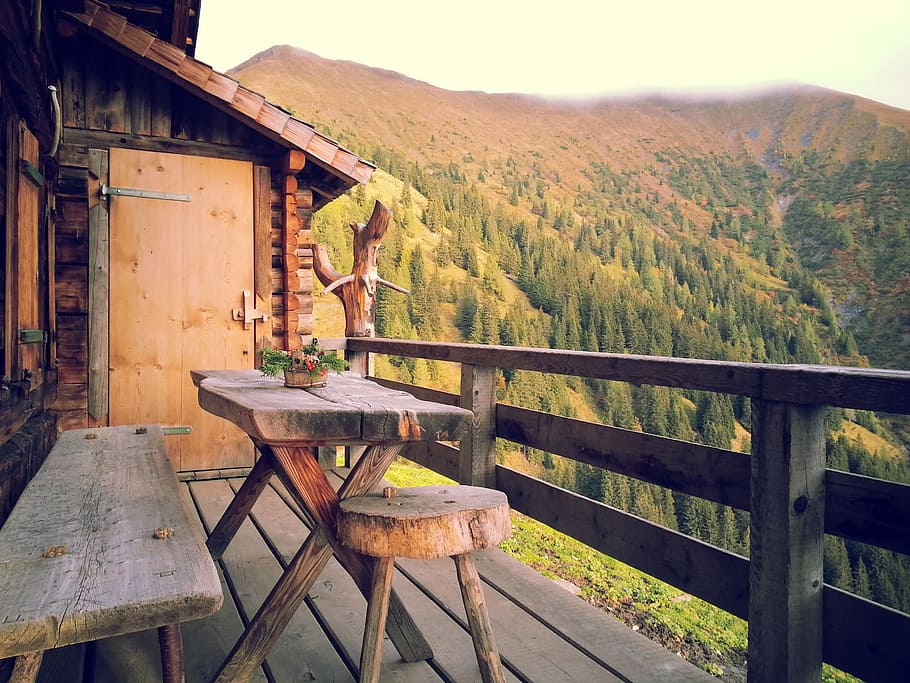 brown wooden table and bench near wooden balcony overlooking mountain at daytime, photo of brown wooden bench and rectangular brown wooden table near brown wooden door photo taken during daytime HD wallpaper